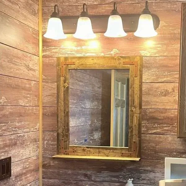 Rustic mirror with shelf in a modern farmhouse bathroom setting