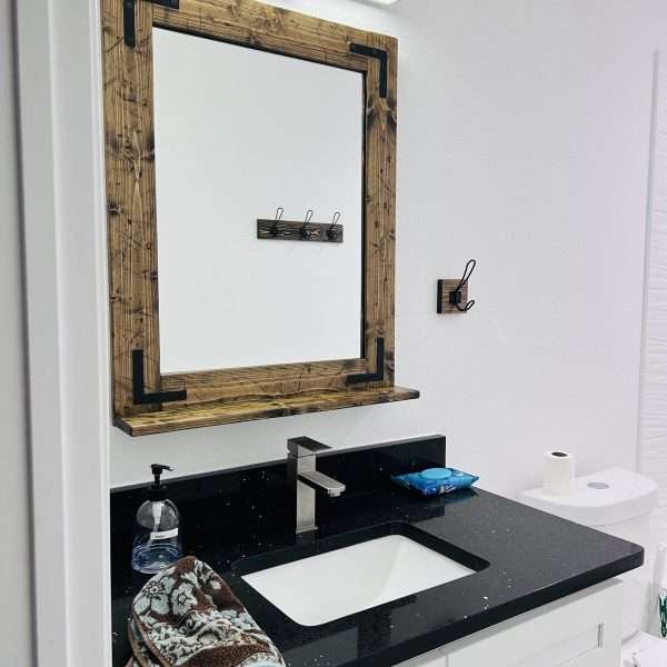Close up of handcrafted wood grain and distressed finish on a farmhouse mirror