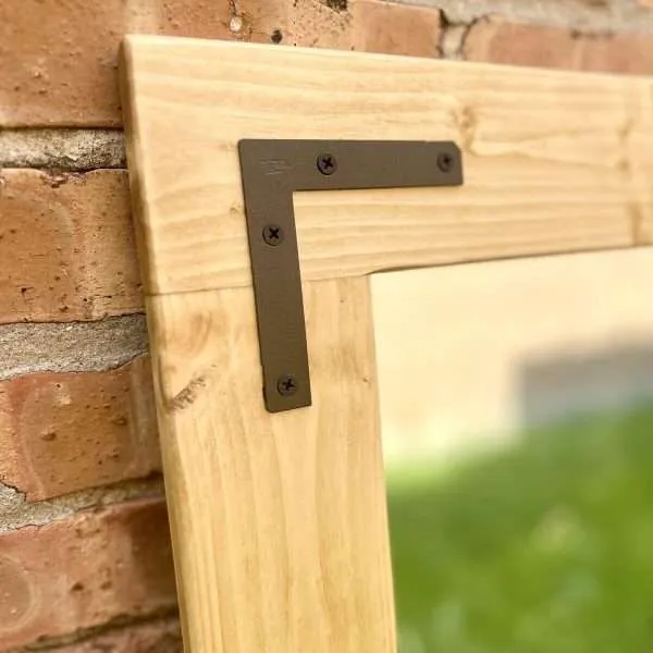Wooden frame with metal corner bracket