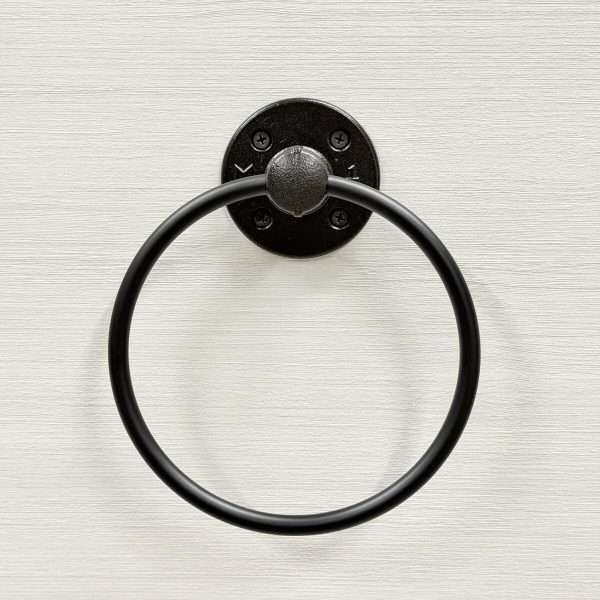 Black metal towel ring on wall