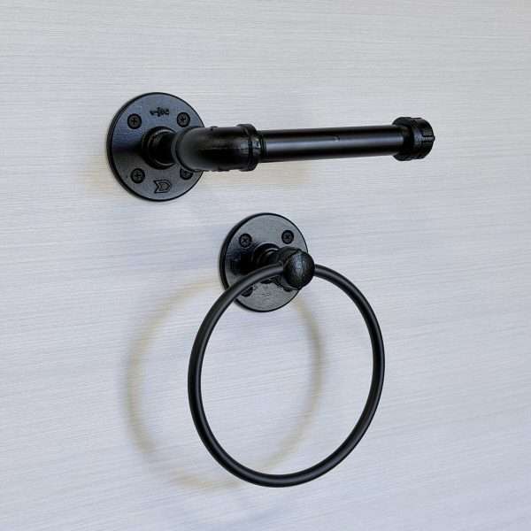 Black towel holder on wall and toilet paper holder set