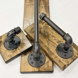 Rustic farmhouse bathroom set of three items including towel hook, towel bar and toilet paper holder on wood board