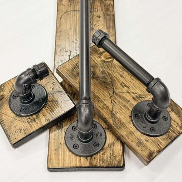 Rustic farmhouse bathroom set of three items including towel hook, towel bar and toilet paper holder on wood board