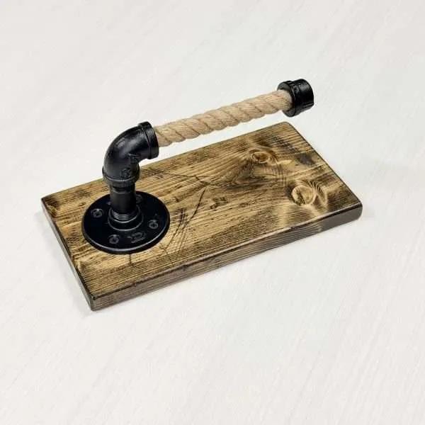 Rustic rope and pipe toilet paper holder on wooden base