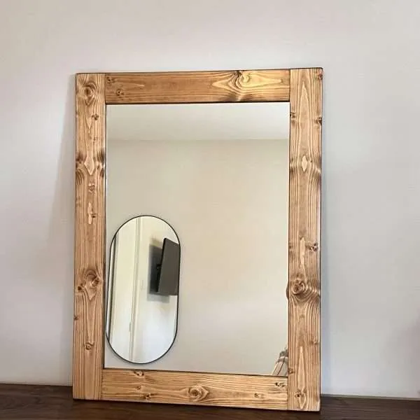 Wooden framed mirror on wall
