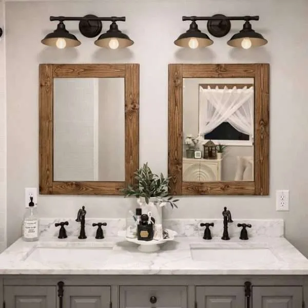 two solid walnut wood frame mirrors on a bathroom wall with 2 sinks under it