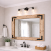 large walnut wood frame mirror hanging on a bathroom wall in a farmhouse bathroom with black hardware on cornets