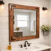 mahogany wood frame mirror hanging on a bathroom wall