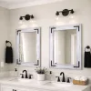 gray whitewash wood frame mirror sitting above a double white vanity in a farmhouse bathroom