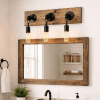 edison light fixture mounted on a bathroom wall