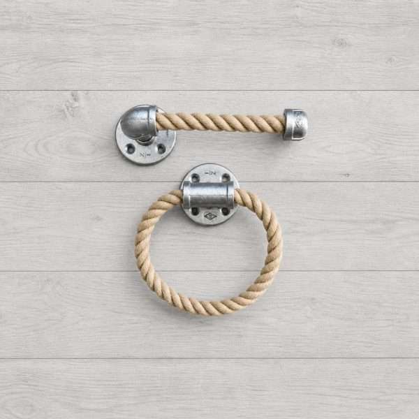 Coastal farmhouse rope bathroom set with towel ring and toilet paper holder on light gray wood background made of silver chrome galvanized pipe and natural rope for bathroom