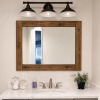 Handmade rustic wood frame bathroom mirror by Lulight Shop mounted above a white vanity with black farmhouse light fixture. Made in Illinois from solid wood with over 19 stain colors available and custom sizing.