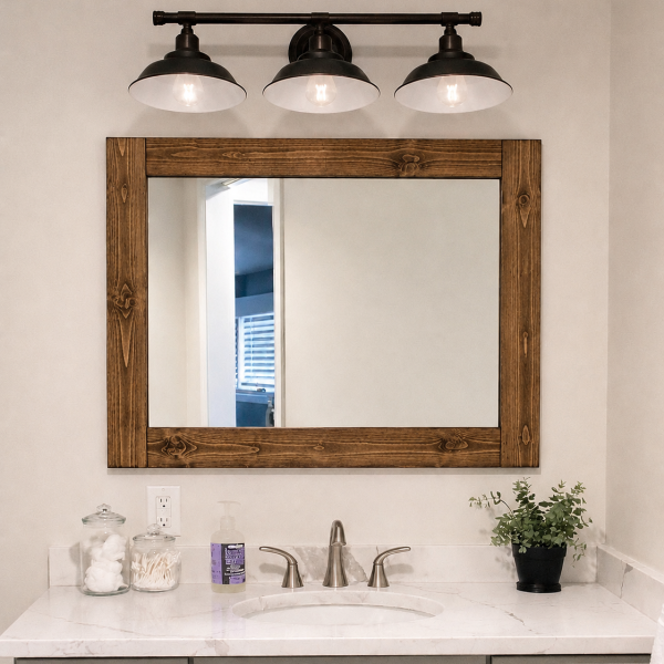 Handmade rustic wood frame bathroom mirror by Lulight Shop mounted above a white vanity with black farmhouse light fixture. Made in Illinois from solid wood with over 19 stain colors available and custom sizing.