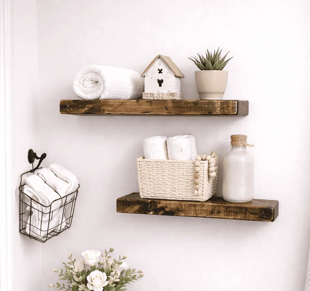 Two handmade rustic floating wood shelves styled with towels and bathroom decor